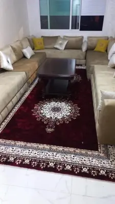 a living room with a couch and a coffee table at Appartement ville des roses in Mohammedia