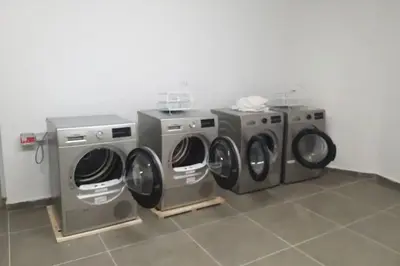 three washing machines and a washer and dryer in a room at Modern and cozy studio Close to CFC & Maarif in Casablanca