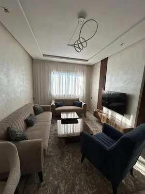 a large living room with couches and a fireplace at Chez BÉA in Rabat
