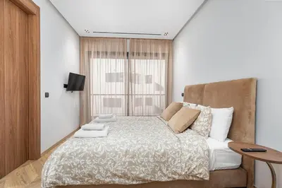 a bedroom with a large bed and a window at Modern & Calm Studio in Casablanca