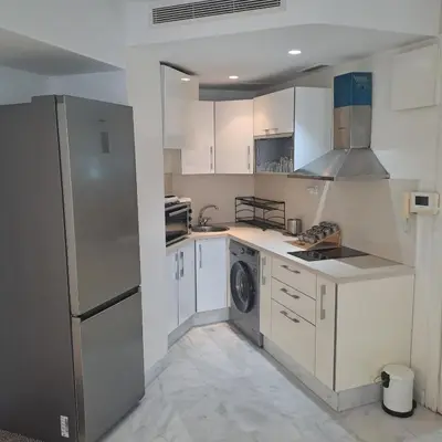a kitchen with white cabinets and a refrigerator at Zen Stay Appart in Casablanca