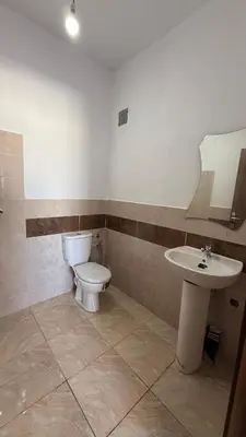 a bathroom with a toilet and a sink at High apartment in Oulad Hamida