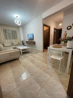 a living room with a couch and a table at High apartment in Oulad Hamida