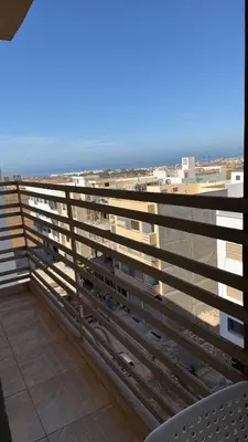 a balcony with a view of the ocean at High apartment in Oulad Hamida