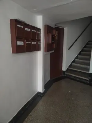 an empty room with stairs and cabinets on the wall at Sense house prime in Rabat