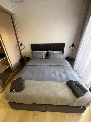 a bedroom with a large bed with two pillows at Studio moderne au centre ville avec wifi rapide in Maarif