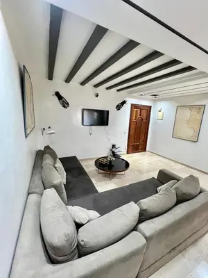 a living room with a couch and a tv at Le repos parfait in Casablanca