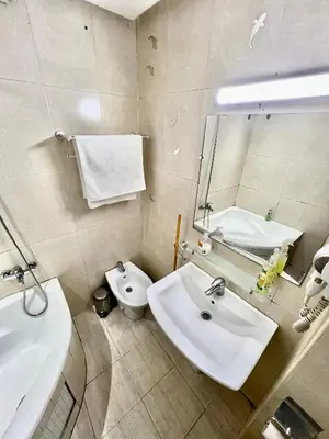 a bathroom with a sink and a toilet and a mirror at Le repos parfait in Casablanca