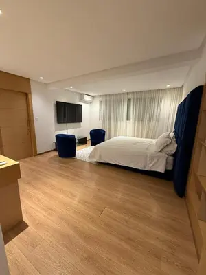 a large bedroom with a bed and a wooden floor at Villa 9- luxurious 5 bedrooms villa in the heart of Ambassadors in Rabat