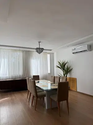 a dining room with a glass table and chairs at Villa 9- luxurious 5 bedrooms villa in the heart of Ambassadors in Rabat