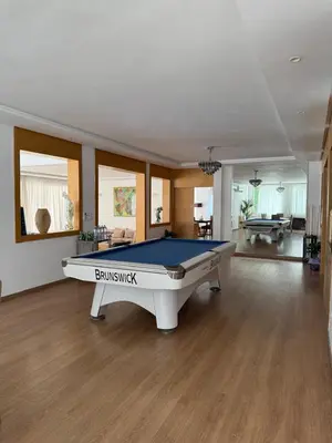 a pool table in the middle of a room at Villa 9- luxurious 5 bedrooms villa in the heart of Ambassadors in Rabat
