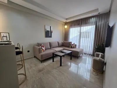 a living room with a couch and a table at Cosy Maarif in Casablanca