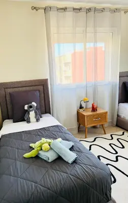 a bedroom with a bed with stuffed animals on it at Cozy & family apartment in Mohammedia in Mohammedia