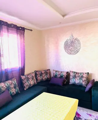 a living room with a couch and a table at Cozy & family apartment in Mohammedia in Mohammedia