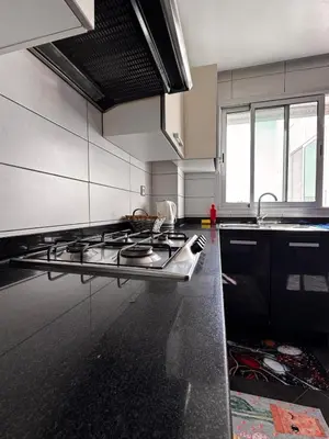 a kitchen with a sink and a stove top oven at Cozy apartment Sea view & Comfort in Mohammedia