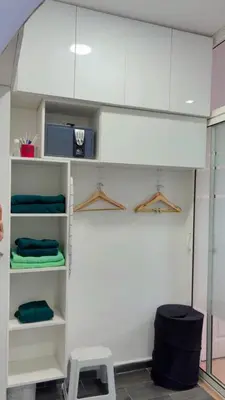 a room with white shelves and a stool at Elégance & Confort in Rabat