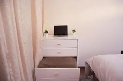 a bedroom with a dresser with a laptop on it at R108- Gorgeous & Cosy Aprt with Wifi, Parking and Gym at the heart of Bourgogne in Casablanca-Port