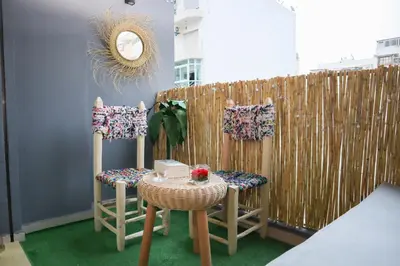 a room with a table and chairs and a fence at R108- Gorgeous & Cosy Aprt with Wifi, Parking and Gym at the heart of Bourgogne in Casablanca-Port