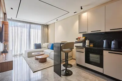 a kitchen and living room with a couch and a table at Blue in Maarif