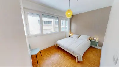 a bedroom with a white bed and two windows at Hotel OMAR BM in Casablanca