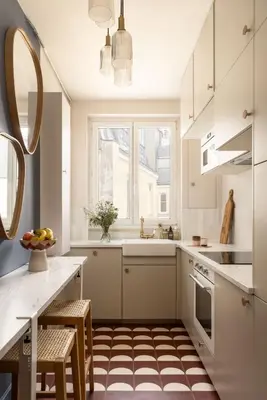 a kitchen with white cabinets and a checkered floor at Hotel OMAR BM in Casablanca