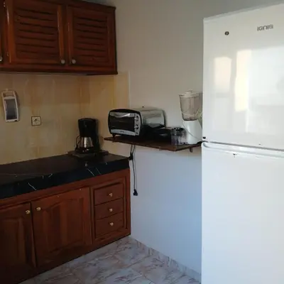 a kitchen with a white refrigerator and a microwave at Appartement Design Prés du Stade My Abdellah in Temara