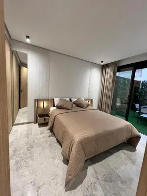 a bedroom with a large bed and a large window at Naturalia Appart & Hotel - Casa Center in Casablanca