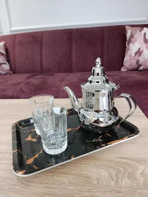 a tea kettle and a glass on a tray on a table at Naturalia Appart & Hotel - Casa Center in Casablanca