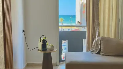 a room with a couch and a view of the ocean at Super appart vue sur mer in Rabat