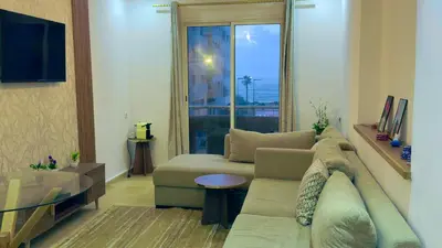a living room with a couch and a large window at Super appart vue sur mer in Rabat