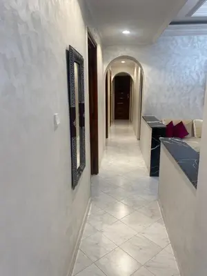 a hallway with a tile floor and a long corridor at Tradition & Modernité in Rabat