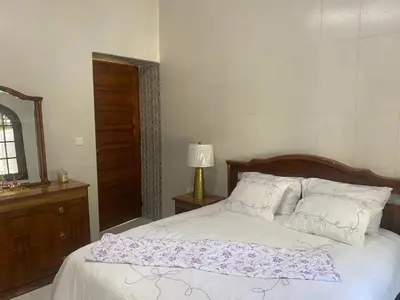 a bedroom with a bed with a purple blanket on it at Tradition & Modernité in Rabat