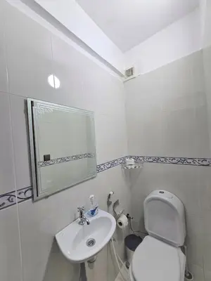 a white bathroom with a toilet and a sink at Appartement Rabat in Rabat