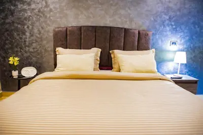 a bedroom with a large bed with two pillows at Cozy Flat with Gym, fast WiFi and Great Location in Casablanca
