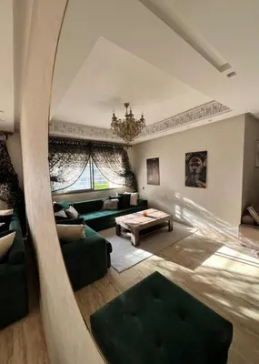 a living room with a large mirror and a couch at Cozy Flat with Gym, fast WiFi and Great Location in Casablanca