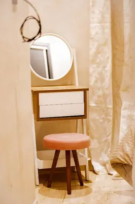 a stool in front of a mirror on a dresser at Cozy Flat with Gym, fast WiFi and Great Location in Casablanca