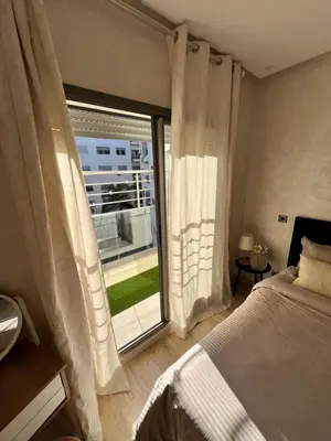 a bedroom with a bed and a large window at Cozy Flat with Gym, fast WiFi and Great Location in Casablanca