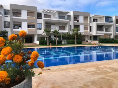 a large apartment building with a swimming pool at Luxury Studio with Pool and Relaxing Atmosphere in O Ben Slimane