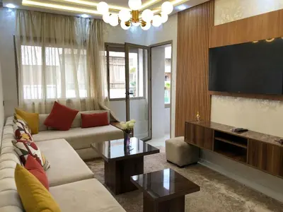 a living room with a couch and a flat screen tv at Luxury Studio with Pool and Relaxing Atmosphere in O Ben Slimane