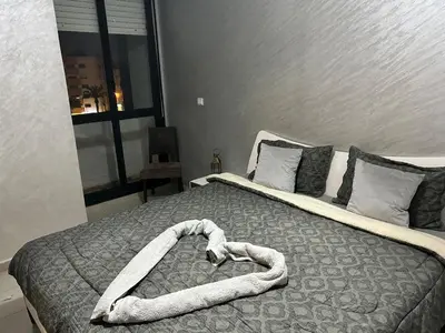 a bed with a heart shaped blanket on it at Régina AppartHotel in Casablanca