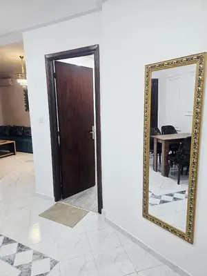 a mirror on a wall next to a door at CHIC Studio - Appartements proche du Arribat Center AGDAL in Rabat