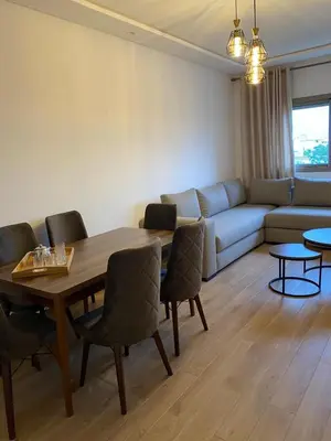 a living room with a table and a couch at Sidi Rahal beach apartment Heaven beach in Sidi Rahal