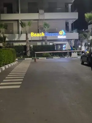 a parking lot in front of a beach recovery sign at Sidi Rahal beach apartment Heaven beach in Sidi Rahal