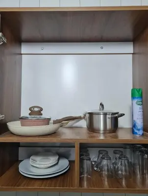 a kitchen counter with a pot and dishes on a shelf at Newly Apartment refurbished central calm charming in Rabat