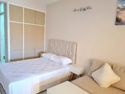 a small bedroom with a bed and a couch at Newly Apartment refurbished central calm charming in Rabat