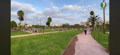 a person walking down a path in a park at Hay laymoun oulfa casablanca Appartement laimoun in Anfa