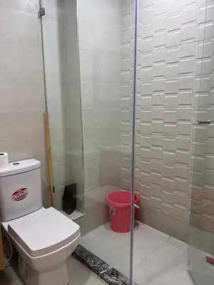 a bathroom with a toilet and a glass shower at Hay laymoun oulfa casablanca Appartement laimoun in Anfa