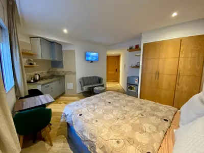 a small room with a bed and a kitchen at Social apartment in Rabat