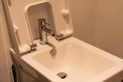 a white sink with a faucet in a bathroom at Luxury Apartment Anfaplace style & elegant in Casablanca