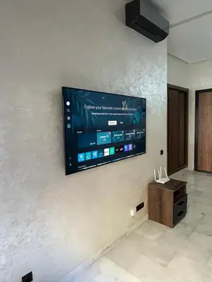 a flat screen tv hanging on a wall at Résidence Natura Living in Mohammedia